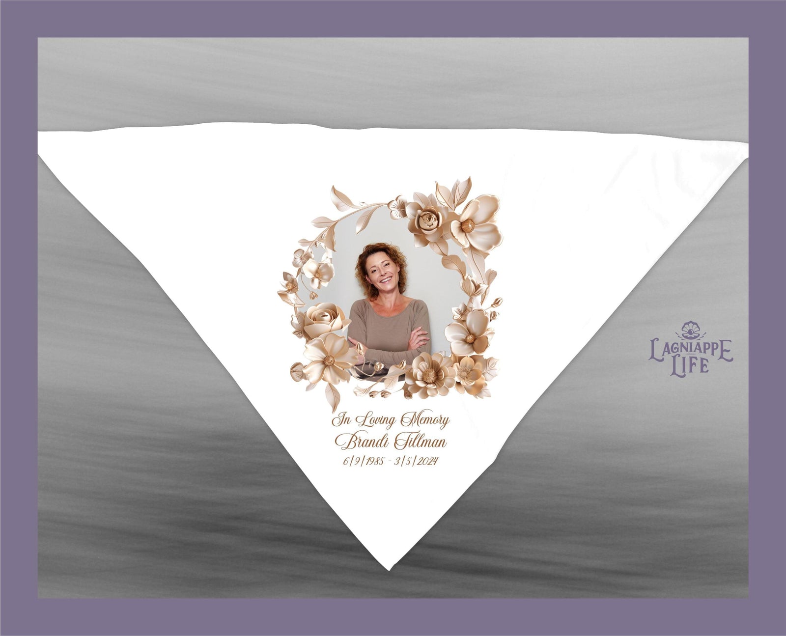 May include: A white handkerchief with a floral design in brown tones. The center of the handkerchief features a photo of a woman with a floral wreath around it. The text 'In Loving Memory Brandi Tillman 6/17/1965 - 3/15/2021' is printed below the photo. The text 'Lagniappe Life' is printed in the bottom right corner of the handkerchief.