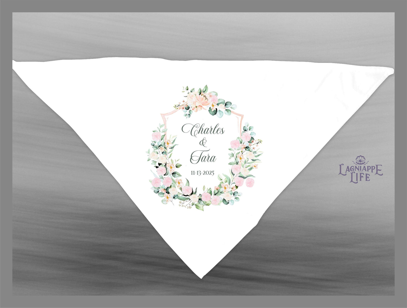 May include: A white wedding favor bag with a floral design and the text 'Charles & Tara 11.13.2025' in the center. The bag has a light pink and green floral wreath with a white shield in the center. The text 'Lagniappe Life' is in the bottom right corner of the bag.
