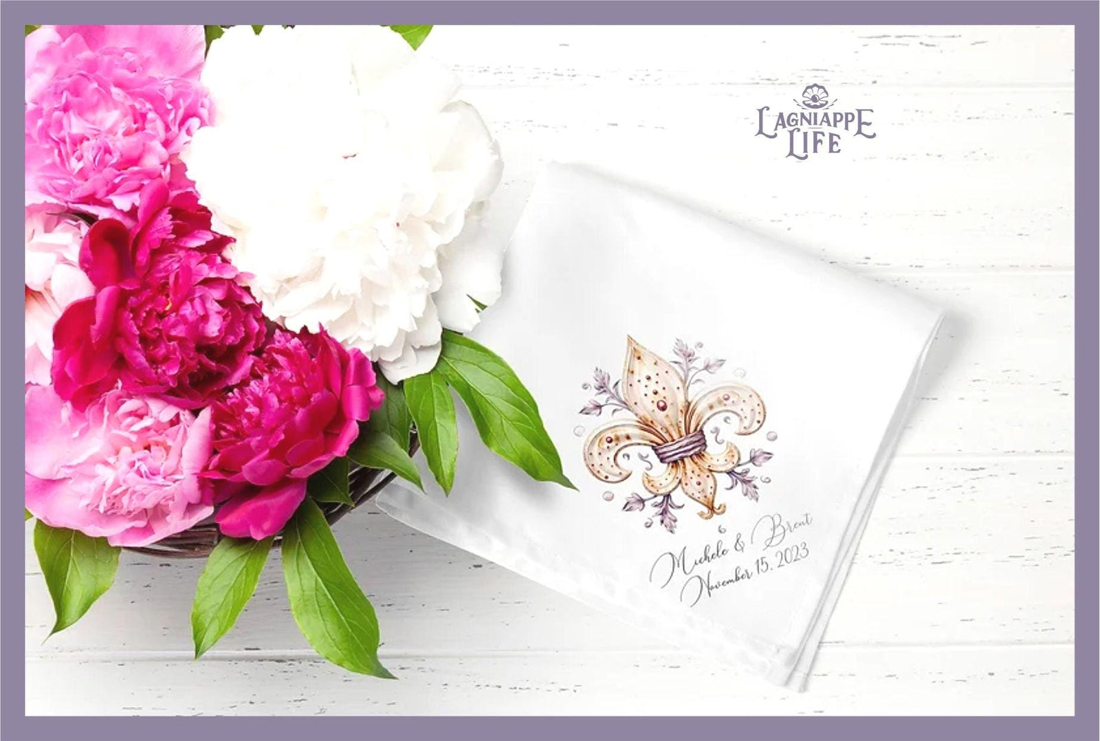 May include: A white linen napkin with a gold fleur-de-lis design and the words 'Michelle & Brent November 15, 2023' in cursive script.