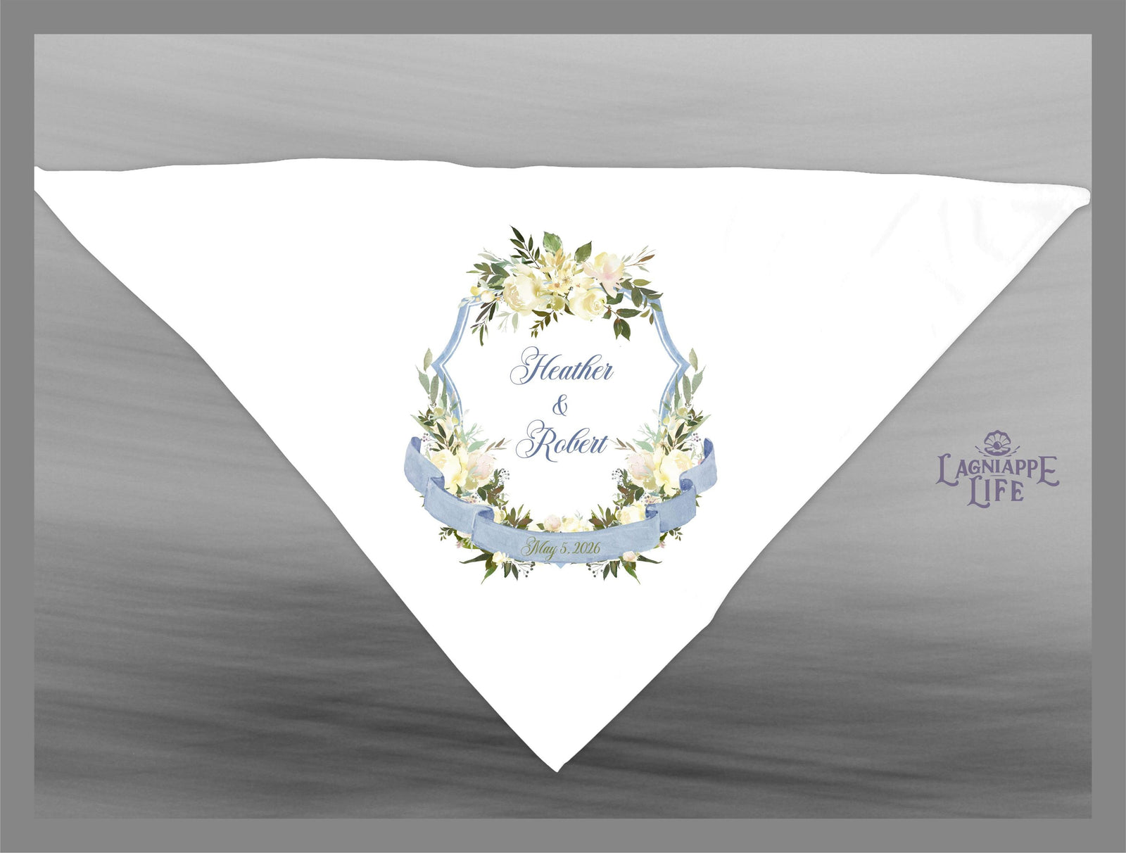 May include: White wedding favor with a blue ribbon and a floral design. The text reads 'Heather & Robert' with a wedding date.