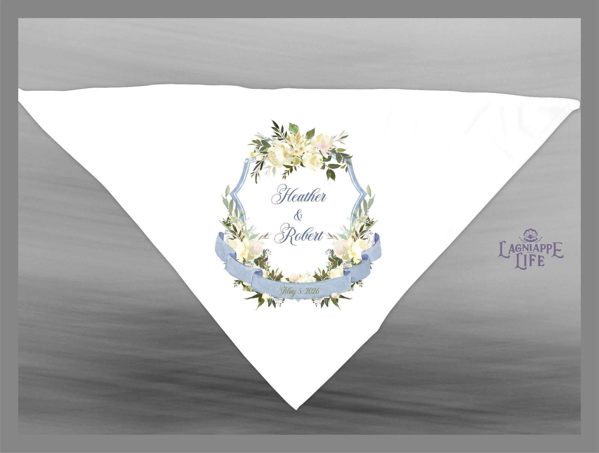 May include: White wedding favor with a blue ribbon and a floral design. The text reads &#39;Heather & Robert&#39; with a wedding date.