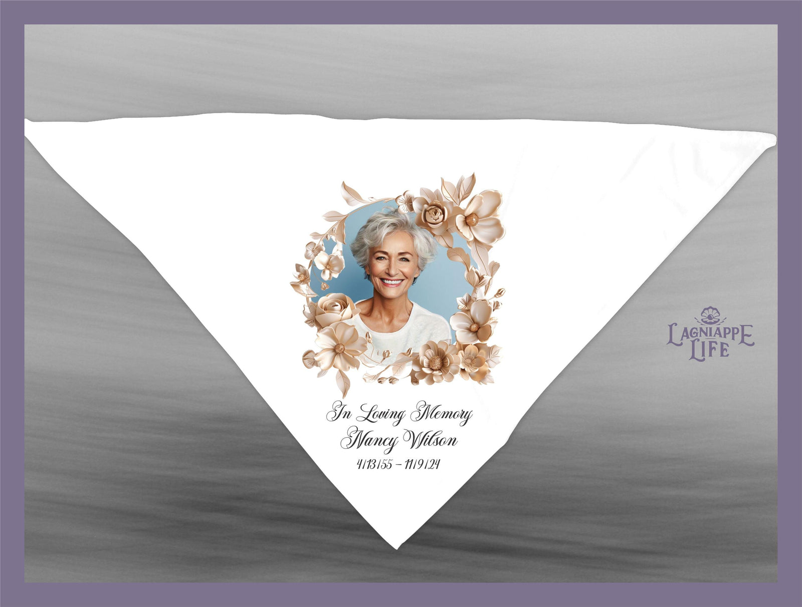 May include: A white triangle shaped fabric with a floral design and a photo of a woman. The text reads 'In Loving Memory Nancy Wilson 9/18/55 - 11/19/24'.