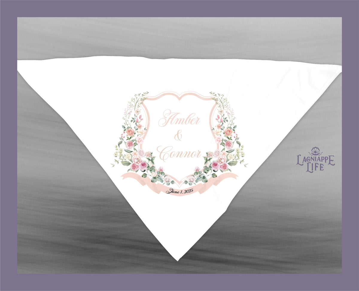 May include: A white wedding handkerchief with a pink floral design and a shield with the text &amp;#39;Amber &amp; Connor&amp;#39; and the date &amp;#39;June 1, 2023&amp;#39;. The text &amp;#39;Lagniappe Life&amp;#39; is in the bottom right corner.